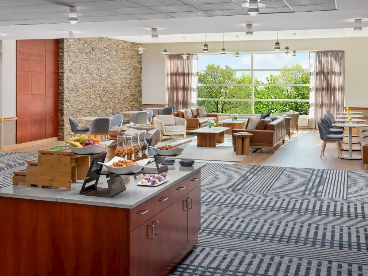 A spacious hotel lobby with a coffee bar counter, comfortable seating, and large windows overlooking greenery, airy and welcoming.